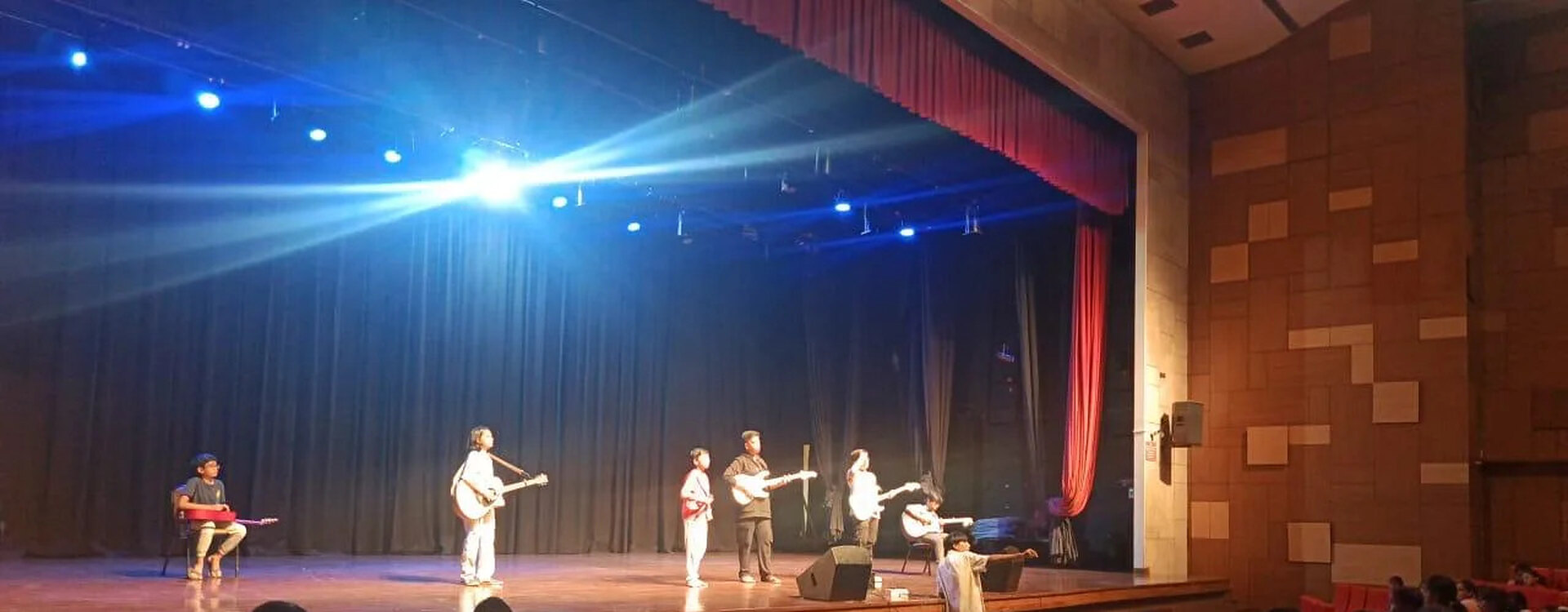 Live band performing to a seated campus audience at a college fest produced by The Show Company