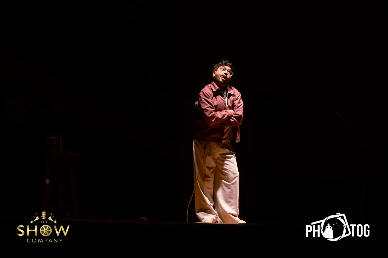 Comedian with arms crossed delivering a deadpan moment