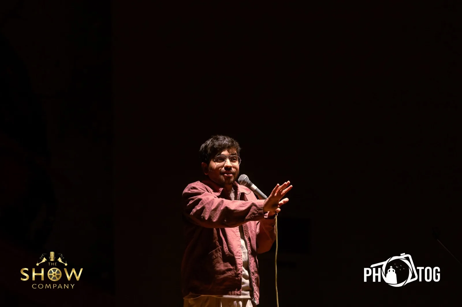 Comedian gesturing to the audience during a bit
