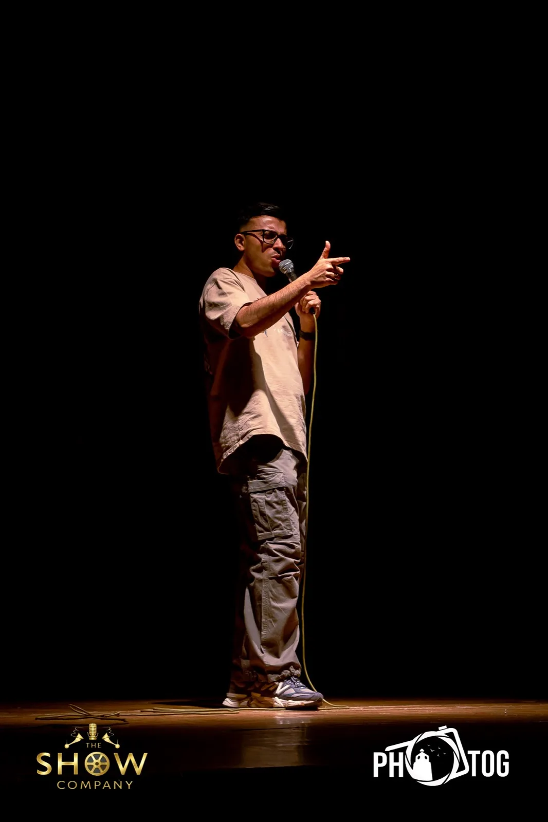 Comedian pointing at the crowd mid-punchline